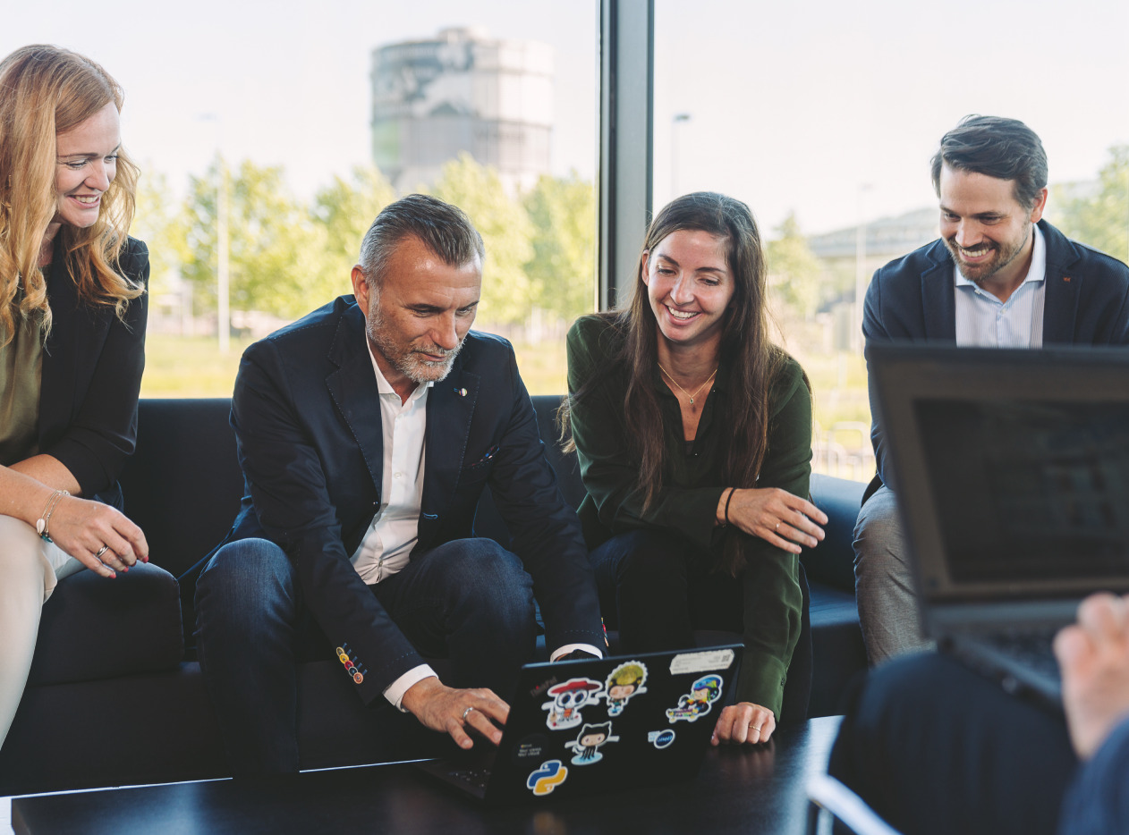 persons around a laptop